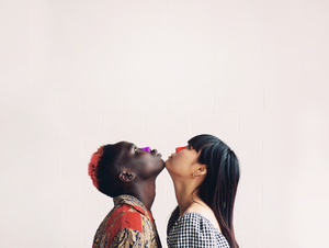 Two people with eco-friendly Noz sunscreen on their noses facing upward looking towards the sky. 